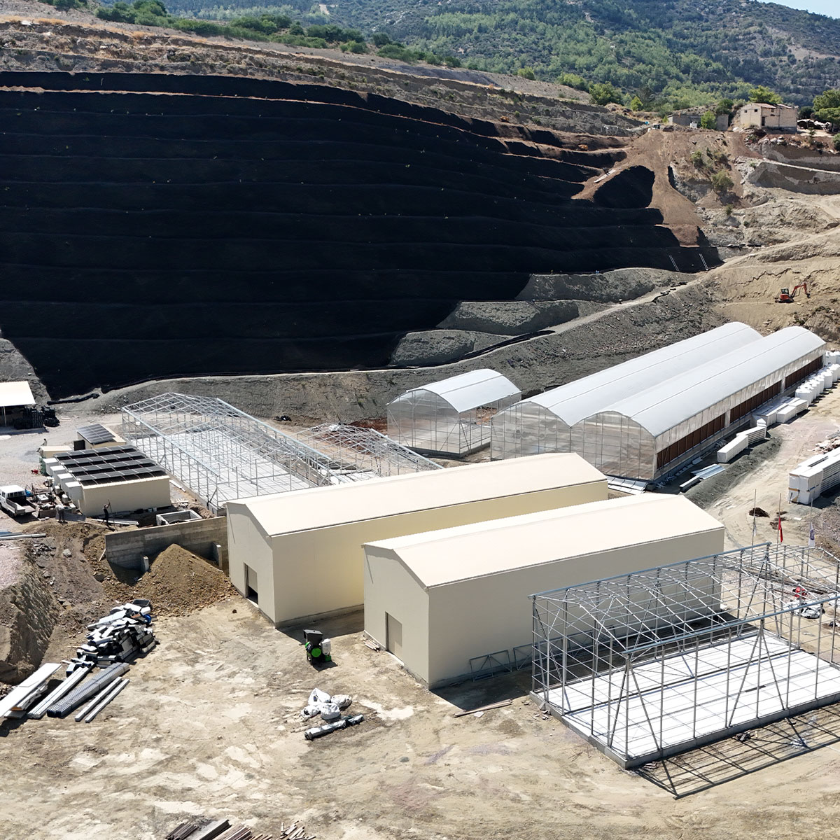 Advanced Cyprus facility build with planted slope preparation and operational structures